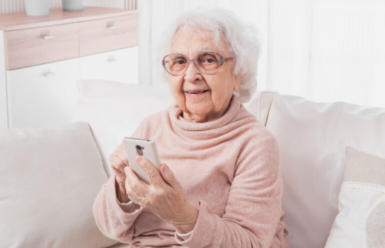 Great-grandmother talking by smartphone